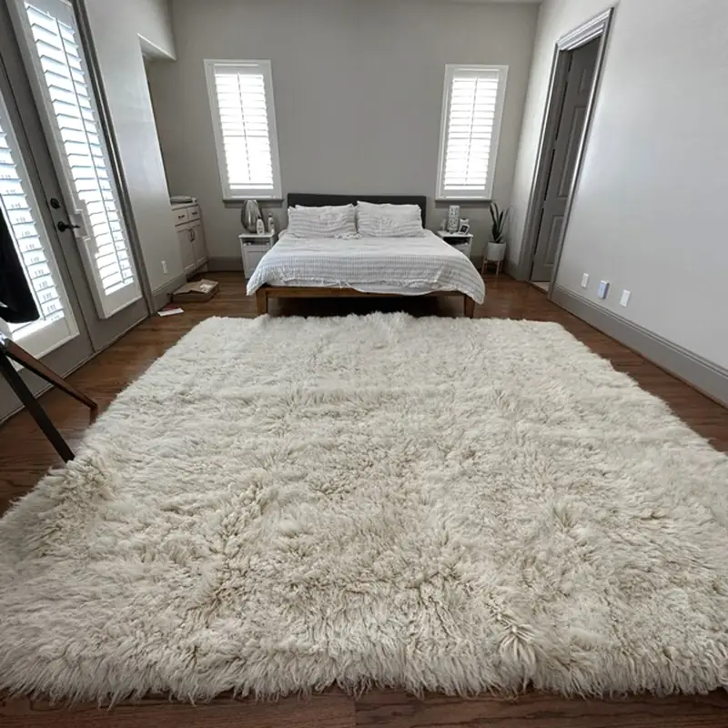Large white shaggy rug in a bedroom setting