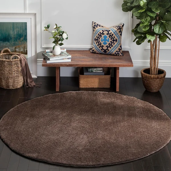 Round dark brown velvet rug in an interior space.